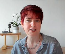 Professor Mary Ryan - woman, seated, with short red hair and a light blue shirt