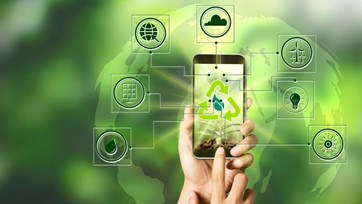 Hand holding a smartphone with recycling logo on the screen