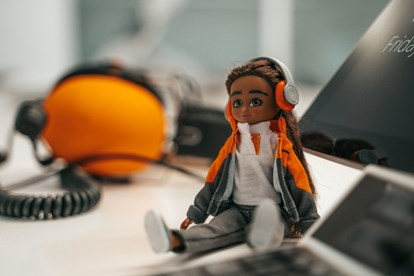 Lottie doll at work, wearing ear protectors