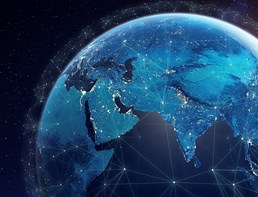 Image of the earth from space, with a grid - representing digital technology - spread out across it