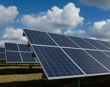 rows of solar panels in a field